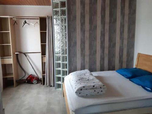 a bedroom with a bed and a room with a refrigerator at maison 475 a parentis in Parentis-en-Born