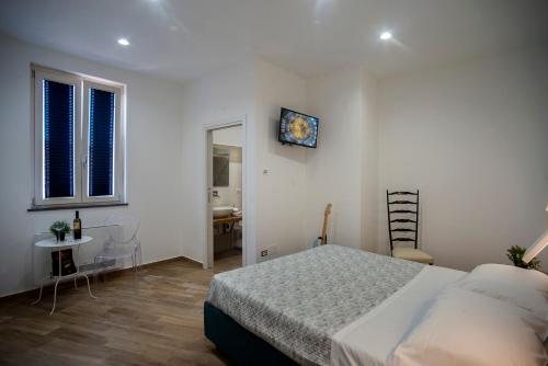 a bedroom with a bed and a table and a mirror at Il Centenario in Ascea