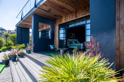 a house with a wooden deck with plants at Chy conary in Carbis Bay