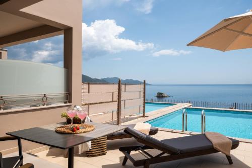 a patio with a table and a swimming pool at Sivota Diamond Spa Resort in Sivota