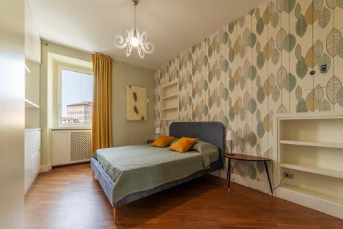 a bedroom with a bed with two orange pillows on it at Vista su San Pietro - la Venere su Roma Apartment in Rome