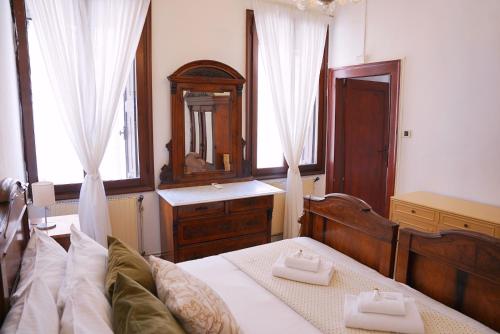 a bedroom with a bed with two white towels on it at Ca' Alle Gondolette in Venice