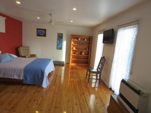 a bedroom with a bed and a television in it at 5 Little Penguin Crt, Cowes in Cowes