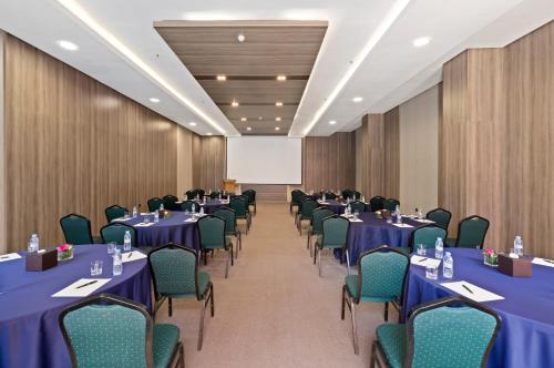 a conference room with blue tables and chairs at Savoy Le Grand Hotel Marrakech in Marrakech