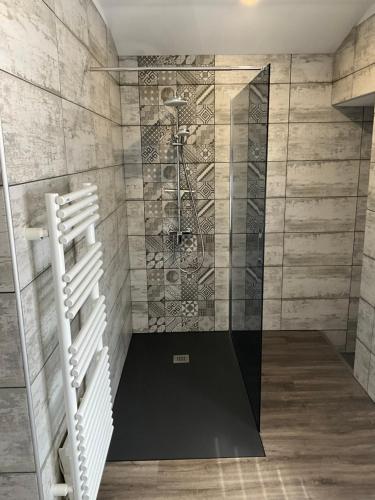 a shower with a glass door in a bathroom at Number9 Studio - Now with air conditioning in Carlipa