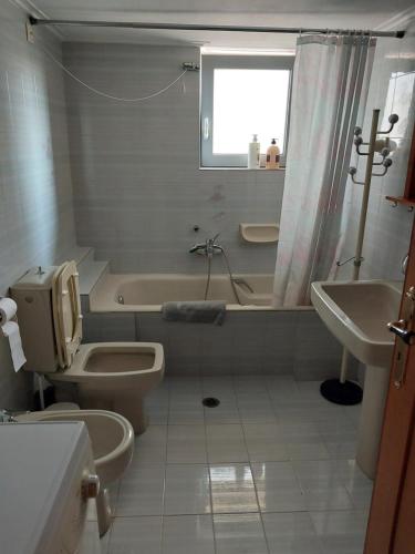 a bathroom with a tub and a toilet and a sink at Passatempo Casa - 3 bedroom apartment close to the swimming pool in Gerani Chanion