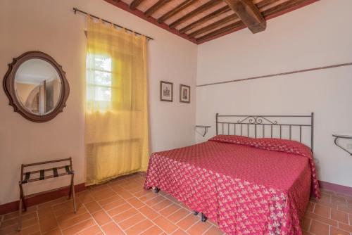 a bedroom with a bed and a mirror at Santo Pietro Resort in San Gimignano