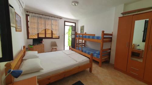 a bedroom with a bed and a bunk bed at Apartments Ognjenović in Risan