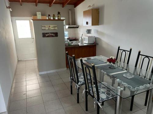 a kitchen with a table with chairs and a refrigerator at Ysati 2 in Mercedes