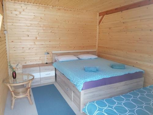 1 dormitorio con 2 camas y mesa. en Hiška Zeleni raj, en Podnart