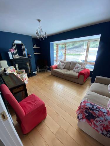 a living room with two couches and a chair at Beach Close Lodge in Kinsale