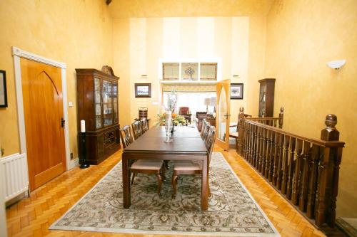 a dining room with a table and chairs at An Boreen in Speenoge