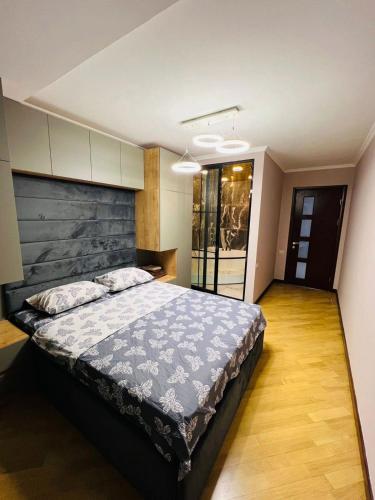 a bedroom with a large bed in a room at City Center Cozy 3Bedroom Apartment with Unique Design and Hot Tub , 2Bathroom, Middle of Center, By Republic Square in Yerevan