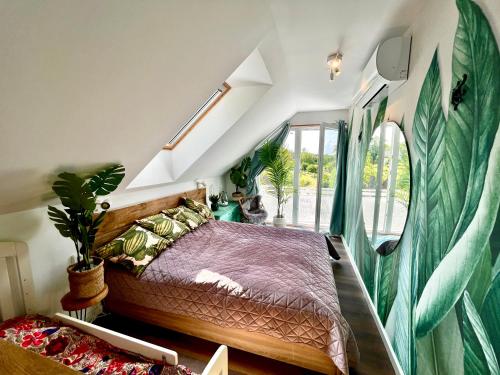 a bedroom with a bed and a window at Bohemian Eco lodge át lake Balaton in Kisapáti