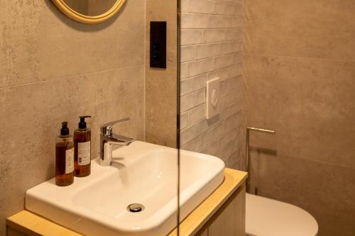 a bathroom with a white sink and a shower at VILLA BASAMAK in Sarajevo