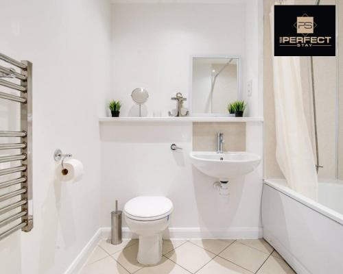 a white bathroom with a toilet and a sink at Horizon Apartment Central By Your Perfect Stay Short Lets Birmingham in Birmingham