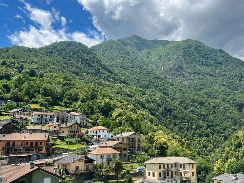 a town in front of a mountain at CASA DEL CIOS calda e intima casetta immersa nel verde delle montagne in Alpe Basciumo