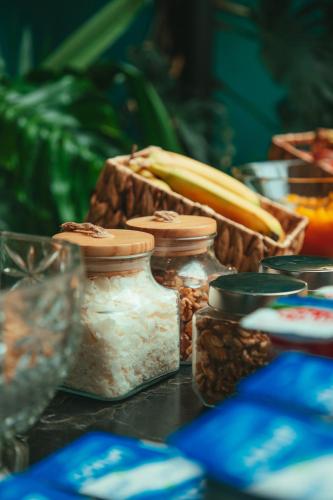 a table with jars of food and a basket of nuts at Hotel Marcos Gamero in Talca