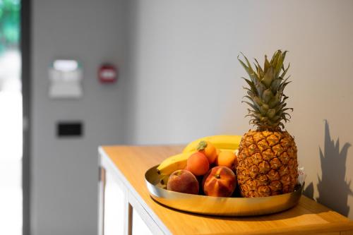 a bowl of fruit on a counter with a pineapple at VILLA BASAMAK in Sarajevo