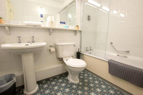 a bathroom with a toilet and a sink at 304 - The Harbour View by Shortstays in Westport