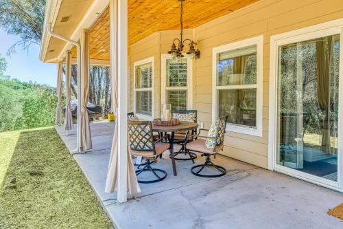 a patio with a table and chairs on a house at Wooded Bliss in Mariposa