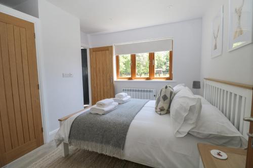 a bedroom with a bed with towels on it at Robins Nest in Fareham