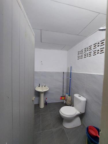 y baño con aseo y lavamanos. en Roomstay Fiq, en Kulim