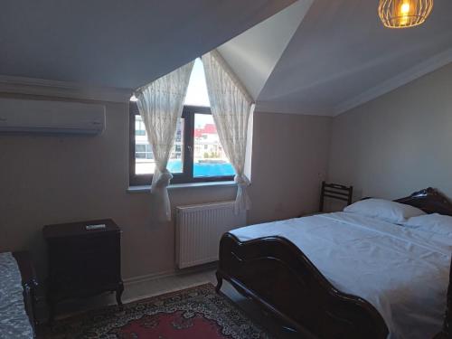 a bedroom with a bed and a window at Guest House in Trabzon