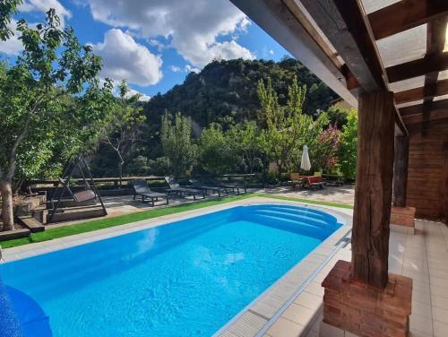 a swimming pool in a yard with a house at Panoramico in Oden