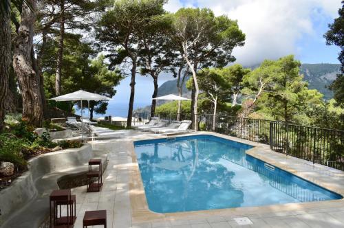 a swimming pool with a view of the mountains at Villa Lia Hotel Capri in Capri
