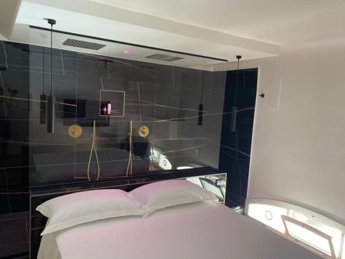 a bedroom with a bed with a mirror on the wall at Wal49 Suite in Bari