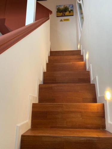 a staircase with wooden floors and white walls at Wal49 Suite in Bari