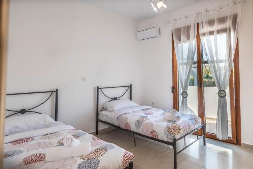 Ένα ή περισσότερα κρεβάτια σε δωμάτιο στο Ciel Blue Villas