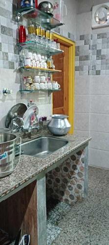 a kitchen with a sink and a counter top at Hotel O POP Rohi Homestay in Gāndarbal