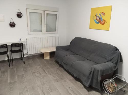 a living room with a couch and a table at PENSION IRATI in Rincón de Soto