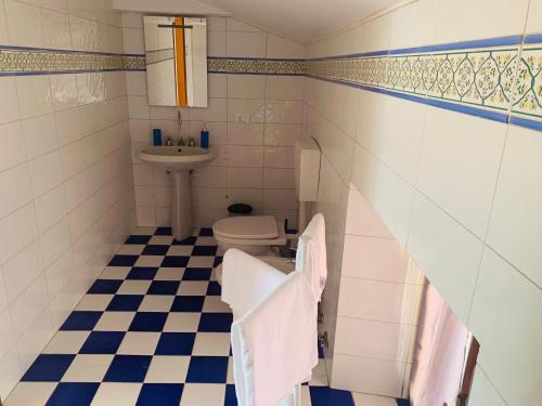 a bathroom with a toilet and a sink at La Chiocciola in Sale