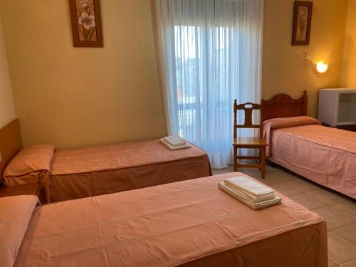 Postel nebo postele na pokoji v ubytování Hostal Jose Mari
