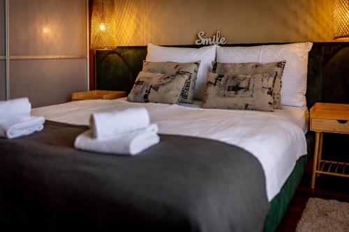 a bedroom with a large bed with white sheets and pillows at Villa Nada in Lovran