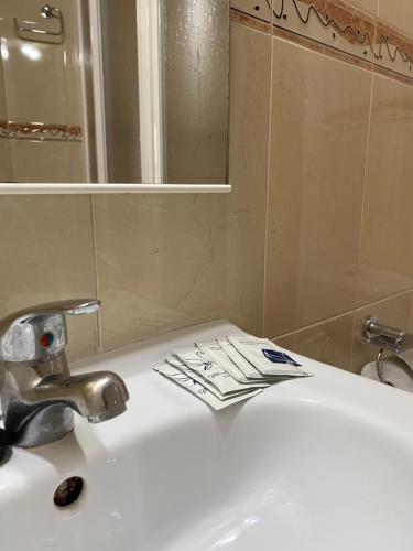 a bathroom sink with a faucet and a mirror at Hostal Jose Mari in Ciudad-Rodrigo