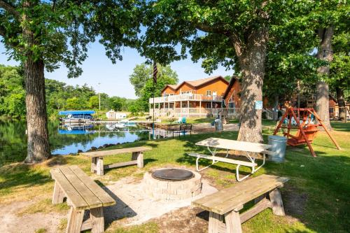 two picnic tables and a fire pit in a park at Thunderbird Resort Condo in Wisconsin Dells