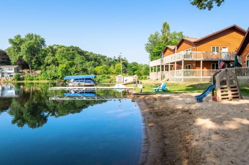 a house next to a river with a house at Thunderbird Resort Condo in Wisconsin Dells
