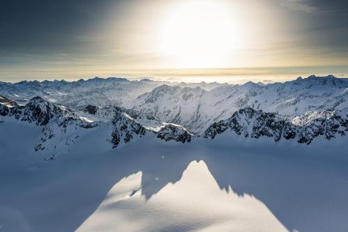 a view of a snow covered mountain with a lake at Appartements Kuprian in Längenfeld