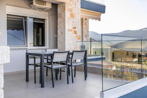 a black table and chairs on a balcony at ONITES Elegant Suites in Skala Potamias