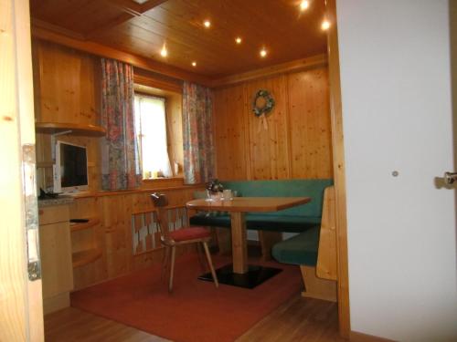 a kitchen with a table and a small table in a room at Apart Sissy in See