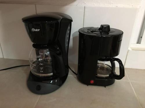 two black coffee makers sitting on a counter at Casita Sac-Nicté in Mahahual
