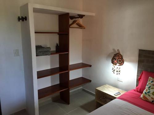 ein Schlafzimmer mit einem Bett und einem Bücherregal in der Unterkunft Casita Sac-Nicté in Mahahual