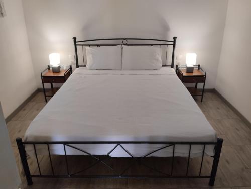 a bed in a room with two side tables at el castle in Agioi Apostoli