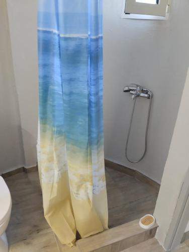 a shower curtain in a bathroom with a toilet at el castle in Agioi Apostoli