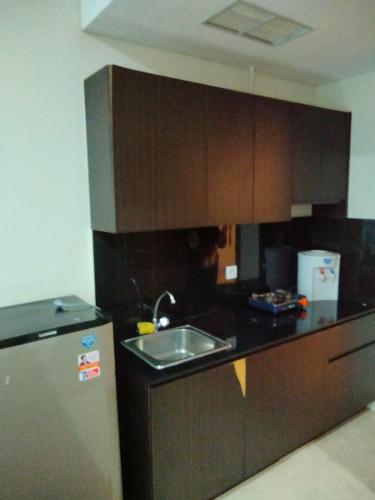 A kitchen or kitchenette at Puri Orchard Apartment