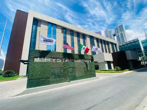 a building with flags on the side of it at Krystal Urban Monterrey San Jeronimo in Monterrey